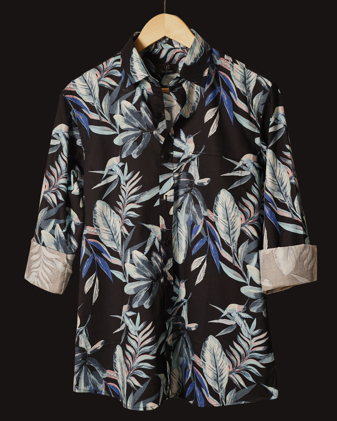 Black cotton shirt adorned with a striking tropical leaf print in shades of blue, grey, and subtle coral accents