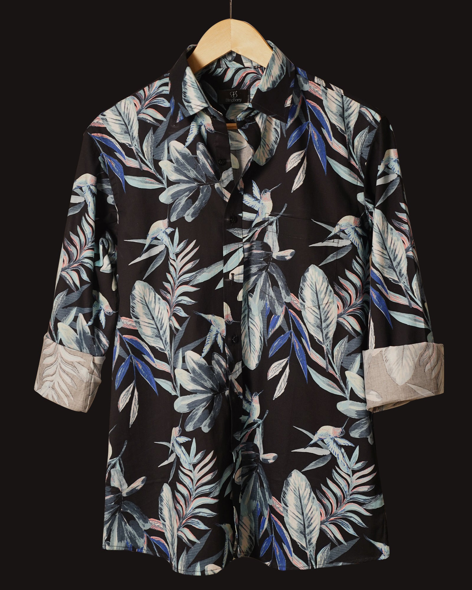 Black cotton shirt adorned with a striking tropical leaf print in shades of blue, grey, and subtle coral accents
